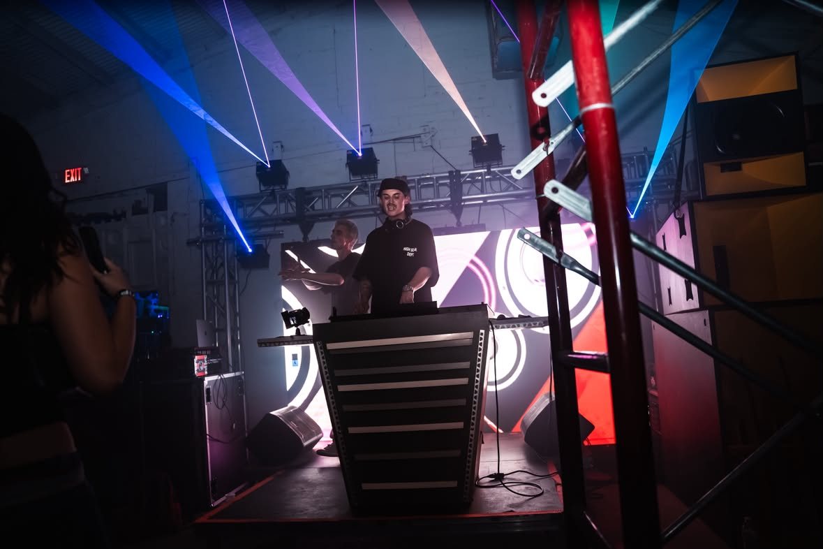 EXGF5 behind the decks under blue and violet lasers