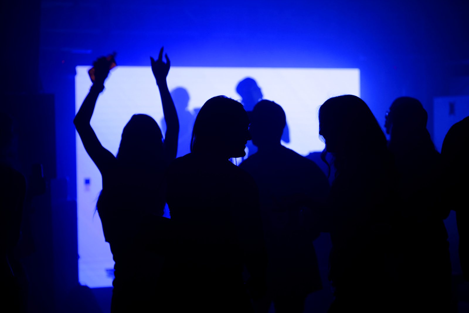 SIGNAL 001 — the crowd lit blue at the secret warehouse